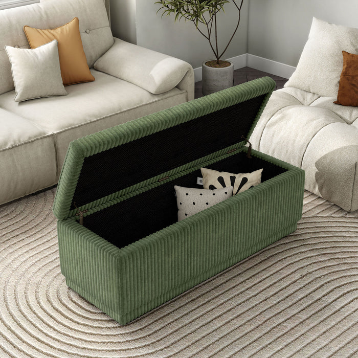 Right facing modern tufted green chenille rectangular storage bench with top lifted in a room with accessories