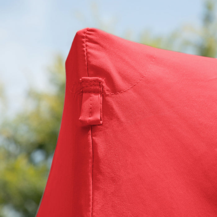 Close up view of the corner of a modern red portable camping gazebo canopy with roof and anchors on an outdoor sky background