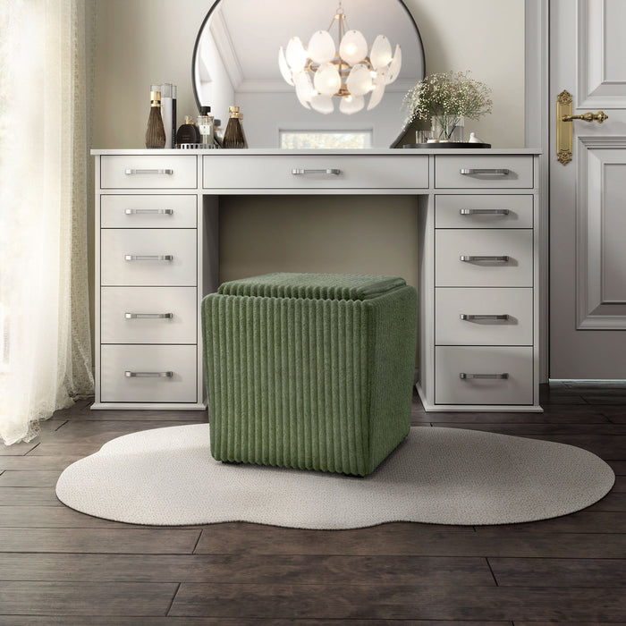 Left facing modern tufted green chenille storage ottoman with a reversible tray top in a room with accessories