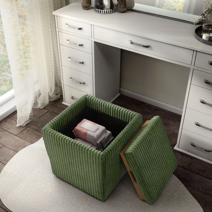 Left facing bird's eye view of a modern tufted green chenille storage ottoman with a reversible tray top in a room with accessories