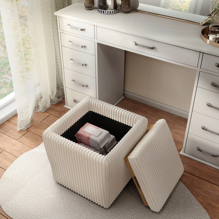 Left facing bird's eye view of a modern tufted beige pink chenille storage ottoman with a reversible tray top in a room with accessories