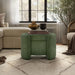 Front facing modern tufted green chenille round storage ottoman with a flip top in a room with accessories
