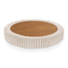 Top only view of a modern tufted beige pink chenille round storage ottoman with a flip top on a white background