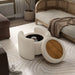 Left facing bird's eye view of a modern tufted beige pink chenille round storage ottoman with a flip top removed in a room with accessories