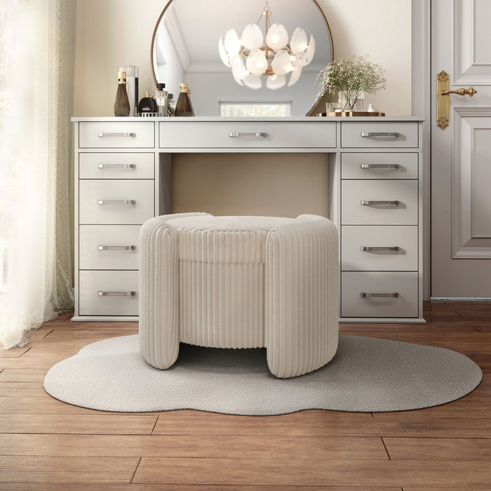 Left facing modern tufted beige pink chenille round storage ottoman with a flip top in a room with accessories