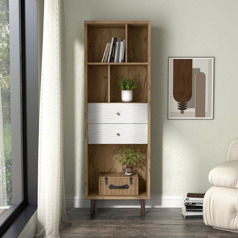 Front facing mid-century modern light oak two-drawer tall bookcase in a room with accessories