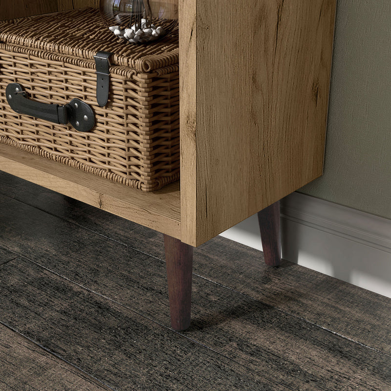 Left facing close up of the leg of a mid-century modern light oak two-drawer tall bookcase in a room with accessories