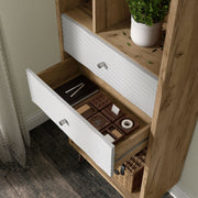 Left facing close up of the drawer of a mid-century modern light oak two-drawer tall bookcase in a room with accessories