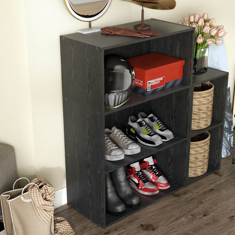 Right facing durable modern three-shelf black storage bookcase in a larger modular configuration in a room with accessories