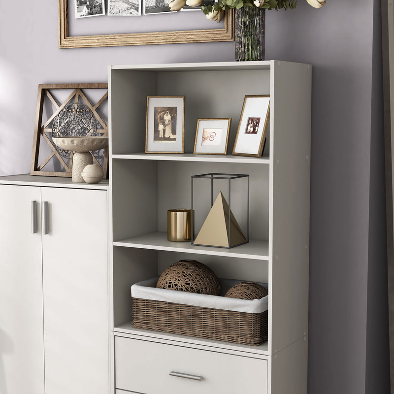 Left facing durable modern three-shelf white storage bookcase in a larger modular configuration in a room with accessories
