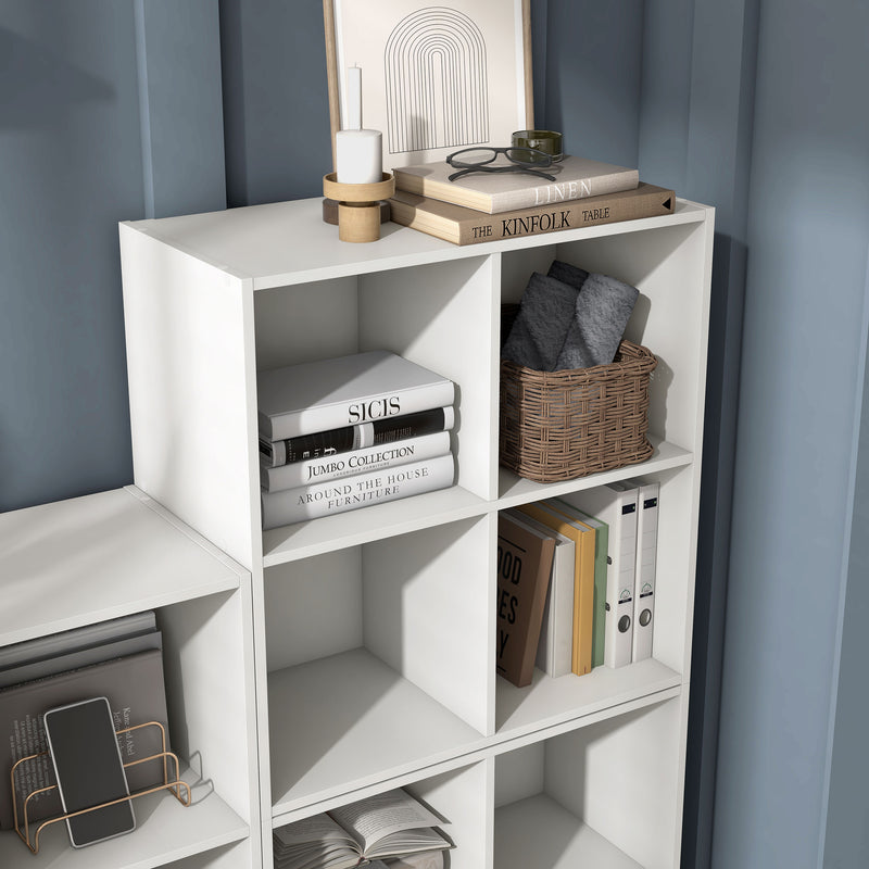 Right facing durable modern four-cubby white storage bookcase as part of a larger modular configuration in a room with accessories