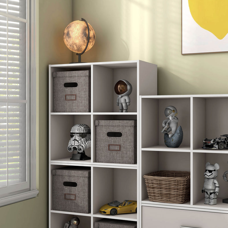 Left facing durable modern four-cubby taupe grey storage bookcase as part of a larger modular configuration in a room with accessories