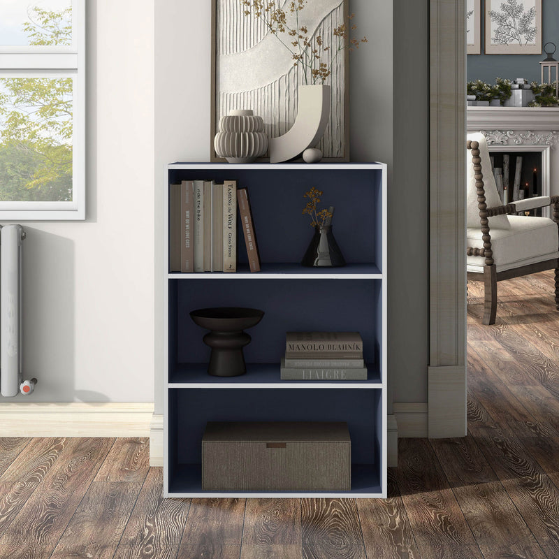 Front facing durable modern three-shelf steel blue storage bookcase in a larger modular configuration in a room with accessories