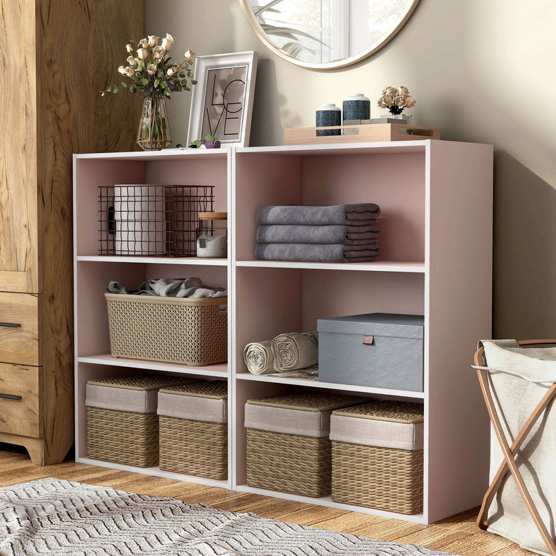 Left facing durable modern three-shelf light pink storage bookcase in a larger modular configuration in a room with accessories