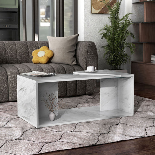 Right facing modern marble finish rectangular coffee table with a glass river tabletop detail in a living room with accessories