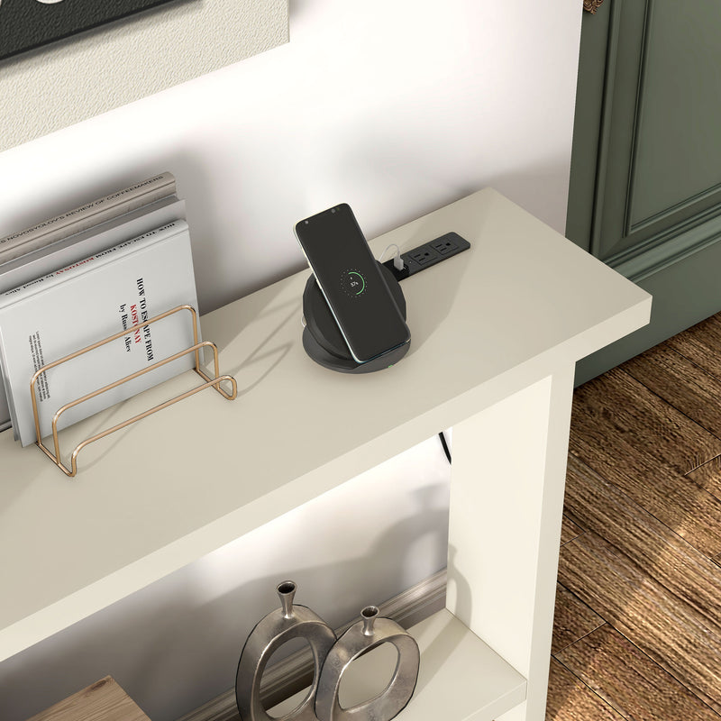 Right facing high close up image of a phone charging on a contemporary soft white rectangular console with a charging panel in a room with accessories