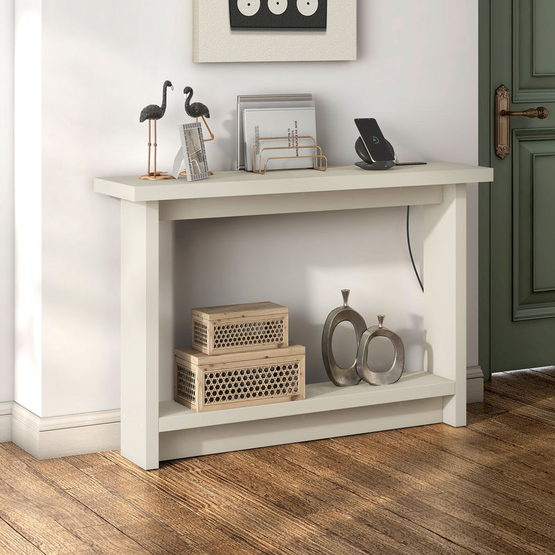 Right facing contemporary soft white rectangular console with a charging panel in a room with accessories