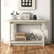 Front facing contemporary soft white rectangular console with a charging panel in a room with accessories