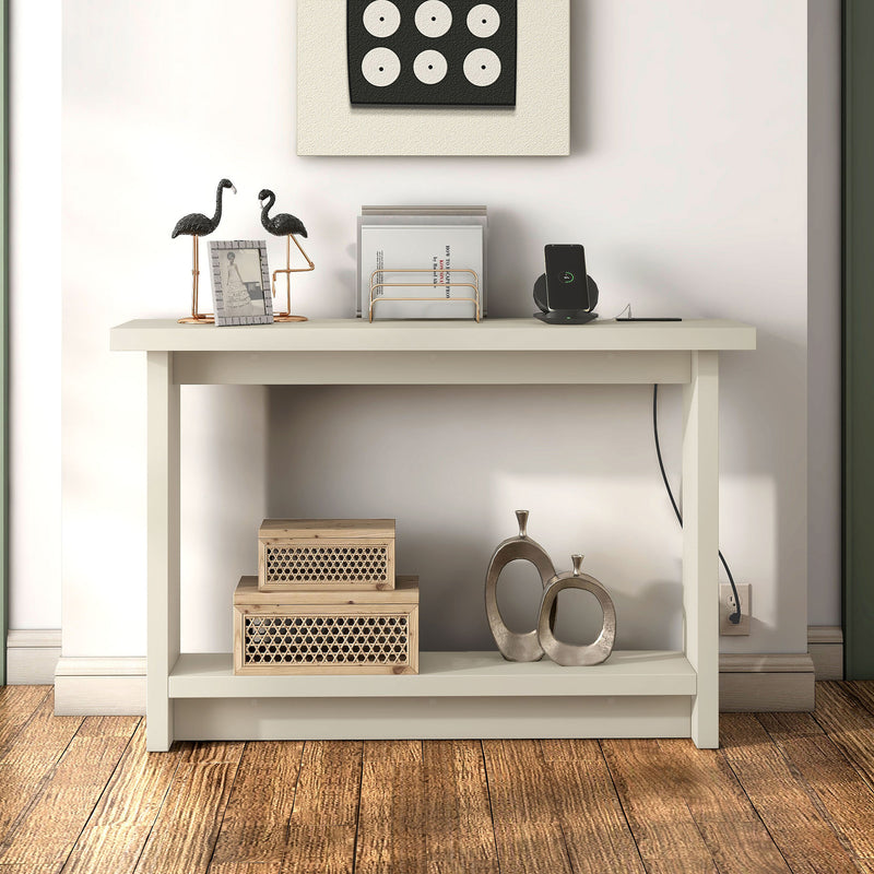 Front facing contemporary soft white rectangular console with a charging panel in a room with accessories