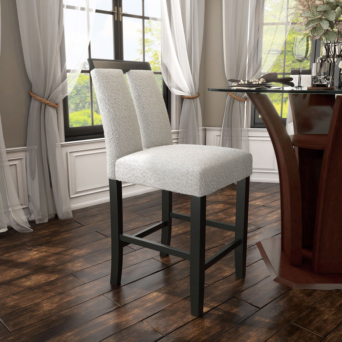 Right facing single view of a set of two contemporary black with white boucle counter height stools in a room with accessories