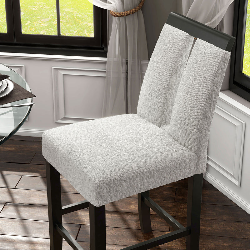 Left facing single view of a set of two contemporary black with white boucle counter height stools in a room with accessories