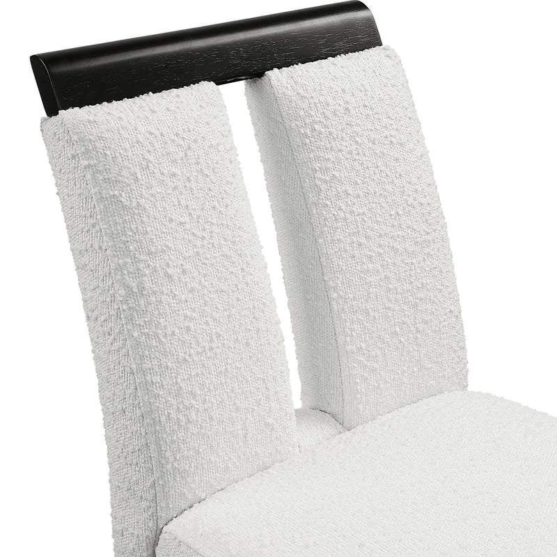 Right facing close up single view of a set of two contemporary black with white boucle counter height stools on a white background