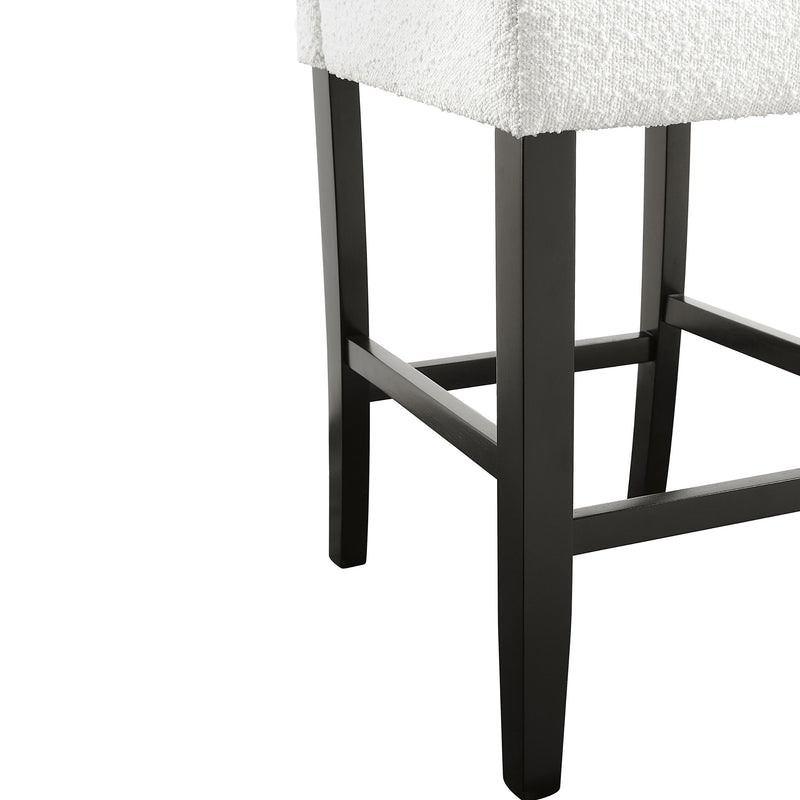 Right facing close up single view of a set of two contemporary black with white boucle counter height stools on a white background