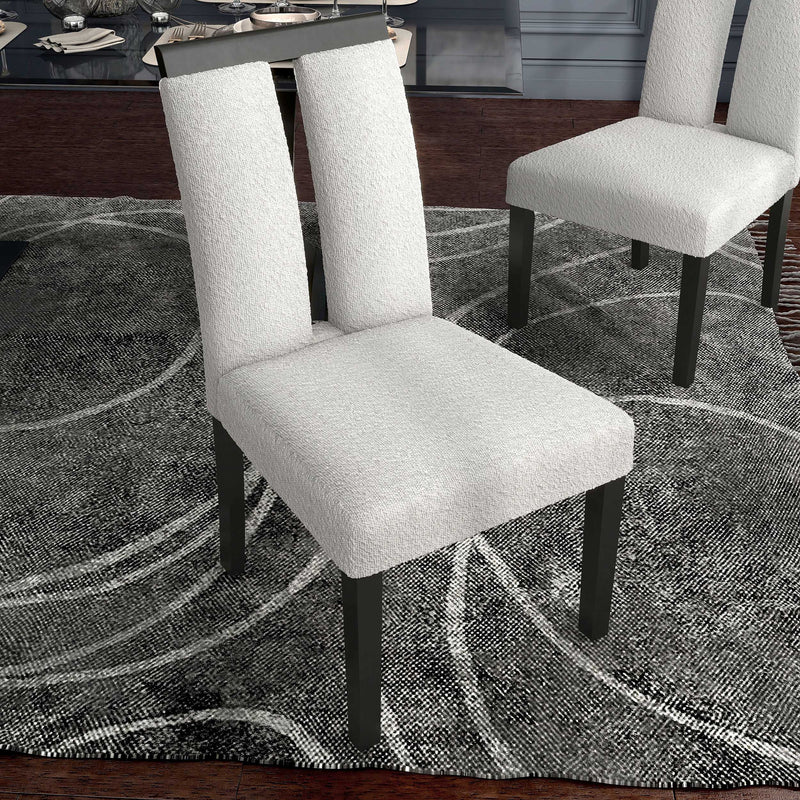 Right facing single view of a set of two contemporary black with white boucle dining side chairs in a room with accessories