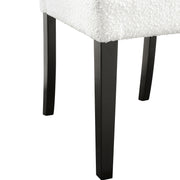 Right facing close up single view of a set of two contemporary black with white boucle dining side chairs on a white background