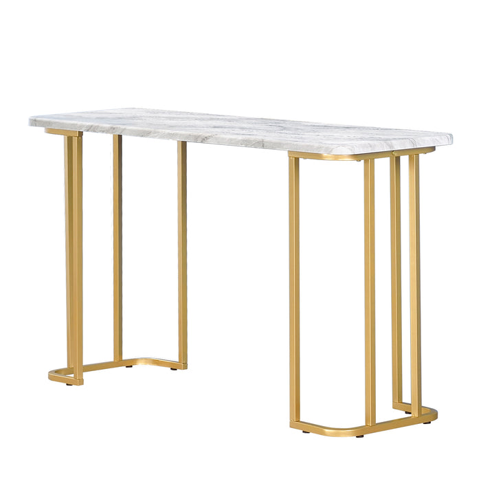 Right angled modern glam white faux marble and gold console table in a living room with accessories