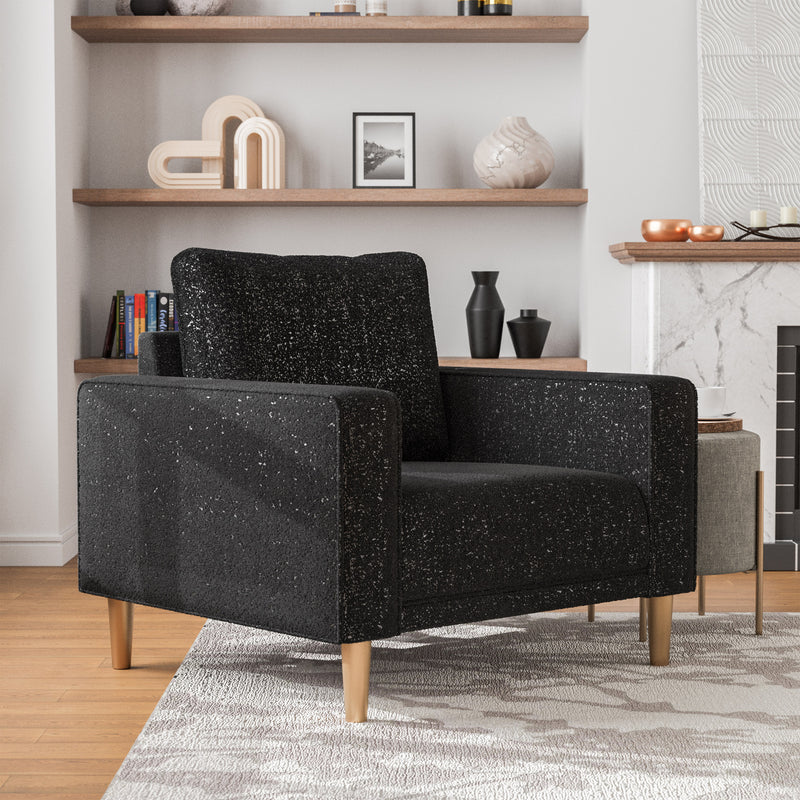 Right facing contemporary black and metallic boucle accent armchair in a room with accessories
