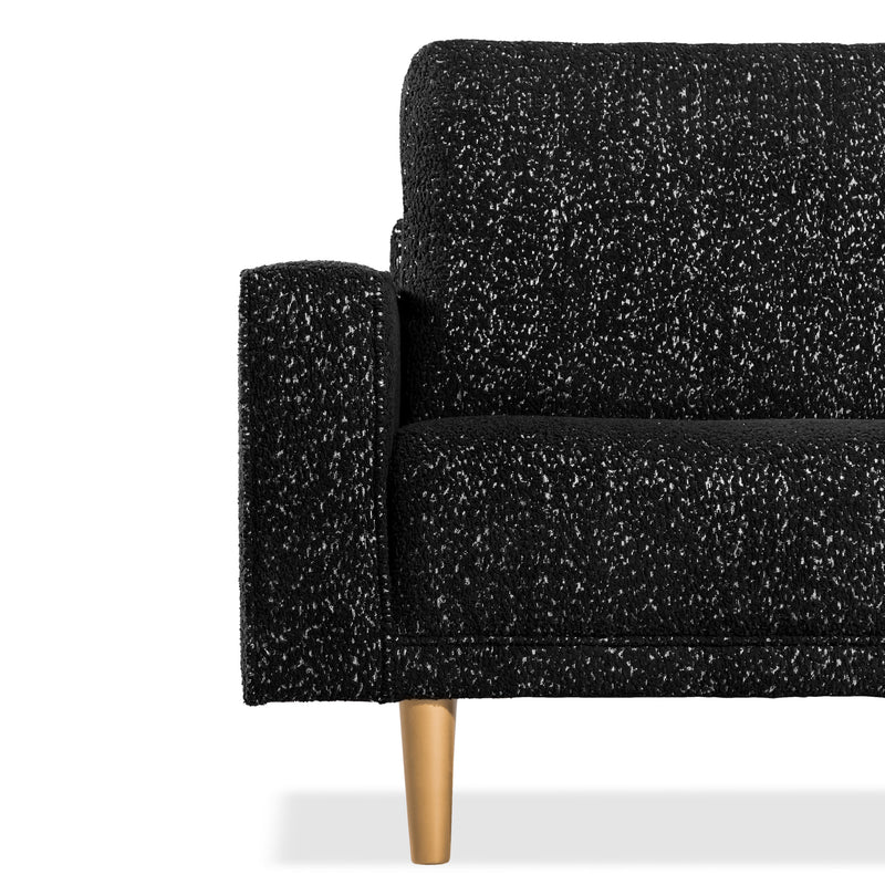Front facing close up of the armrest, leg and upholstery of a contemporary black and metallic boucle accent armchair on a white background