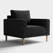 Right facing contemporary black and metallic boucle accent armchair on a white background