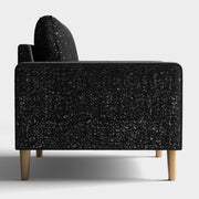Front facing side view of a contemporary black and metallic boucle accent armchair on a white background
