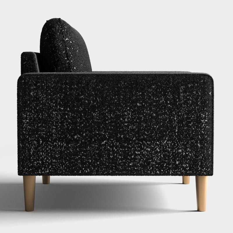 Front facing side view of a contemporary black and metallic boucle accent armchair on a white background