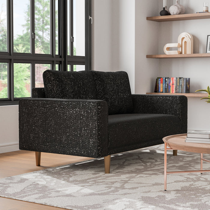 Right facing contemporary black and metallic boucle loveseat in a room with accessories