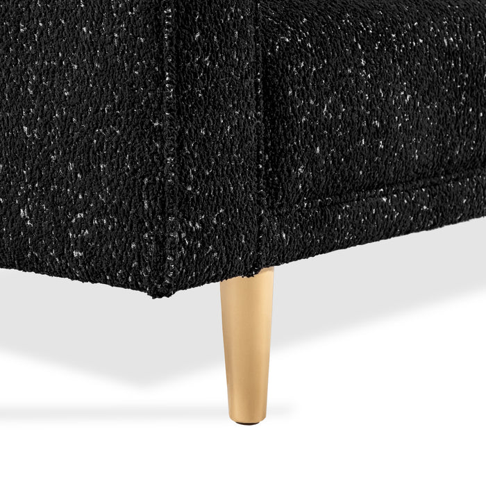 Right facing close up of the leg and upholstery of a contemporary black and metallic boucle loveseat on a white background