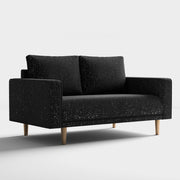 Right facing contemporary black and metallic boucle loveseat on a white background