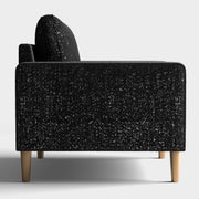 Front facing side view of a contemporary black and metallic boucle loveseat on a white background
