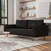 Left facing contemporary black and metallic boucle sofa in a room with accessories