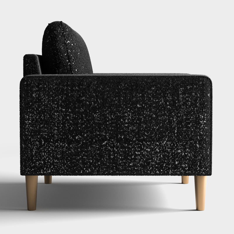 Front facing side view of a contemporary black and metallic boucle sofa on a white background