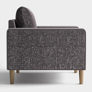 Front facing side view of a contemporary charcoal gray and metallic boucle accent armchair on a white background