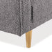 Right facing close up of the leg and upholstery of a contemporary charcoal gray and metallic boucle loveseat on a white background
