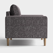 Front facing side view of a contemporary charcoal gray and metallic boucle loveseat on a white background