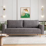 Front facing contemporary charcoal gray and metallic boucle sofa in a room with accessories