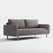 Right facing contemporary charcoal gray and metallic boucle sofa on a white background