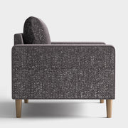 Front facing side view of a contemporary charcoal gray and metallic boucle sofa on a white background