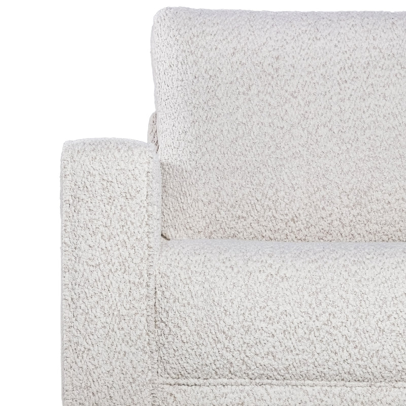 Front facing close up of the armrest and upholstery of a contemporary off-white metallic boucle accent armchair on a white background
