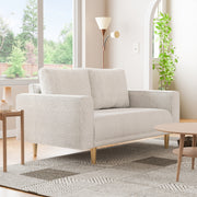 Right facing contemporary off-white metallic boucle loveseat in a room with accessories