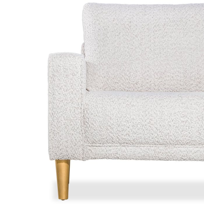 Front facing close up of the armrest, leg, and upholstery of a contemporary off-white metallic boucle loveseat on a white background